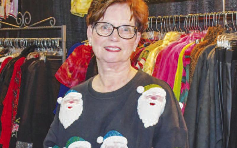 YOUR SHOP – Carolyn smiled at the Your Shop vendor stand, selling clothes to attendees of the Fa La La event at Levelland’s Mallet Event Center &amp;amp; Arena Dec. 12. (Staff photo by Evin Thomas)