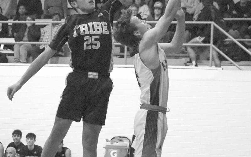 HIGH - Whitharral Panther Brolin Kennedy layed the ball up during the teams fast break opportunity last Tuesday night against the Morton Indians at home where Morton Indian E.J. Rivas jumped with him to play good defense and force a tough shot. (Staff photo by Aalijah Soliz)