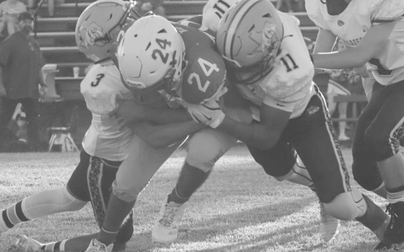 DOWN YOU GO - Bulldogs Jose Avalos and Shooter Campos brought down the Chiilicothe ballcarrier last Friday in Motley County during the team’s win. (Staff photo by Aalijah Soliz)