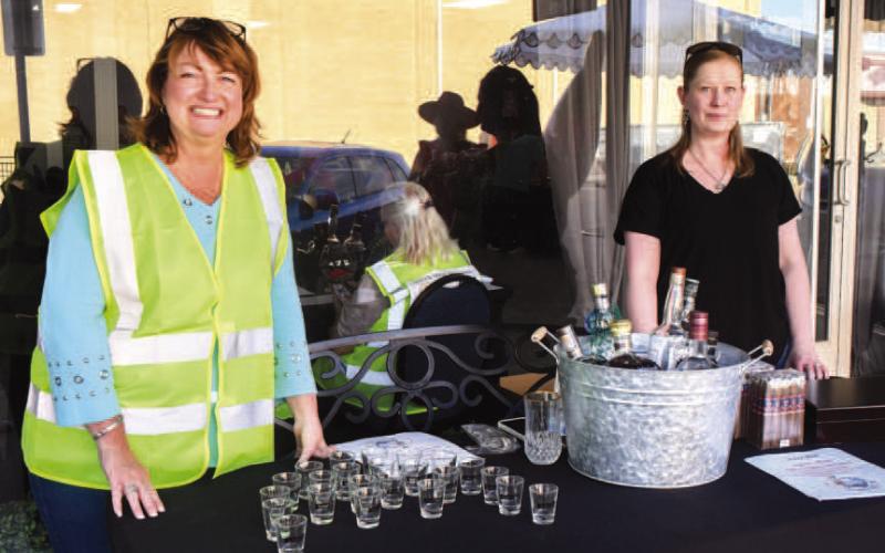 Tammy Franklin and Maryan Moore were set up outside of Studebakers VIP lounge in downtown Levelland during Friday night’s Sip and Swirl event. (Staff photo by Evin Thomas)