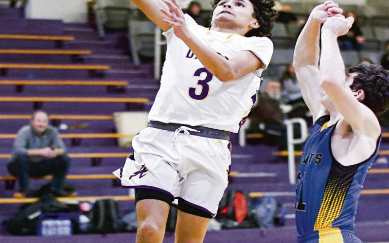 TAKIN’ FLIGHT - Anton Bulldog Shooter Campos takes flight to score the basket with a Wellman Union defender guarding him during their game this past Friday night at Anton High School. (Staff photo by Jentezen Smith)