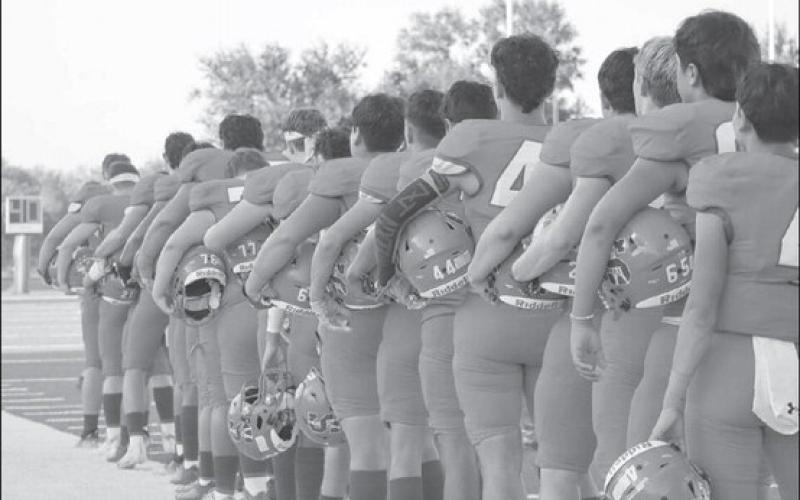 NATIONALANTHEM - The Sundown Roughnecks lined up on their sideline to face the flag while their band played the National Anthem before their homecoming game started last Friday. (Staff photo by Aalijah Soliz)