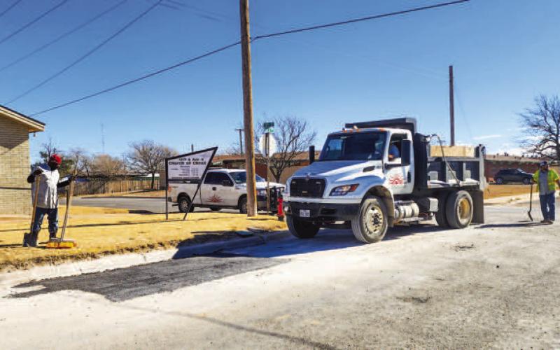 POTHOLE REPAIRS - A crew with the Levelland Street’s Department convened at the corner of 13th Street and Avenue K to repair a pothole, Thursday afternoon. Pictured is one of the crew passing over the repaired area multiple times to help pack down the newly laid material. (Staff photo by Dom Puente)