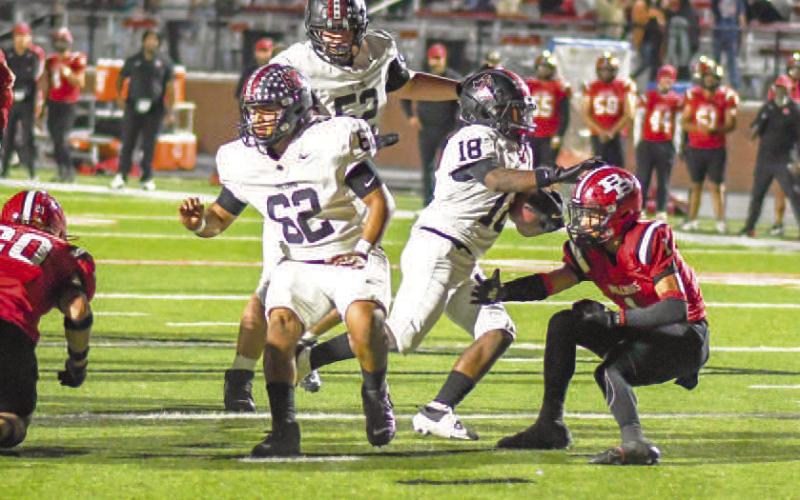 FINISHINGTHE DRIVE - Points came at a premium for the Levelland Lobos during Friday night’s matchup against the Borger Bulldogs. The Lobos would put up 14 points and hold off the Bulldogs to secure their first district win. Pictured is RB Noah Martin finding an open lane thanks to his offensive lineman Zarian Valderas and Casen Potter then cutting across the last Bulldog defender for the walk-in touchdown in the first half. (Staff photo by Dom Puente)