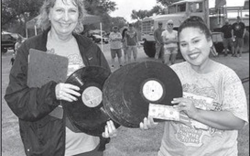 ROCKINGRECORDFLING– The annual Thunder on the Plains held its Rockin Record Fling event Saturday in the City Park. Pictured with Thunder on the Plains representative, Lydia Turner, is second place winner Holly Gonzales. The winners of the Rockin Record Fling won a cash prize. (Staff Photo)