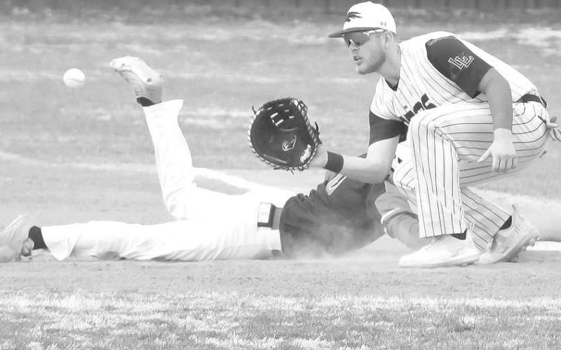 PICK OFF- Lobo Tyler Pemberton tried to pick-off a runner at first during the Levelland Line Drive Classic Thursday. The Lobos were matched up against Borger. Tournament played continued Friday and Saturday. (Staff Photo by Dom Puente)