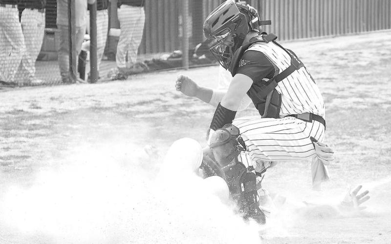 PLATE TAG- Lobo Rusty Johnson tagged a runner at home plate during the Levelland Line Drive Classic Thursday. The Lobos were matched up against Borger. Tournament played continued Friday and Saturday. (Staff Photo by Dom Puente)