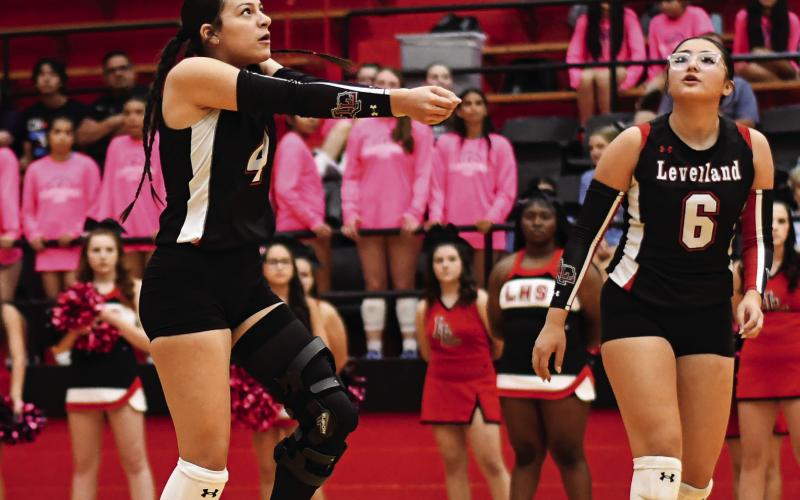 PASS IT AROUND - Senior opposite hitter Yara Carillos passes the volleyball as Hailee Estrada watches during Levelland’s volleyball match against Frenship Memorial this past Tuesday night at Levelland High School. The Loboettes would end up falling to Memorial 3-0. (Staff photo by Jentezen Smith)