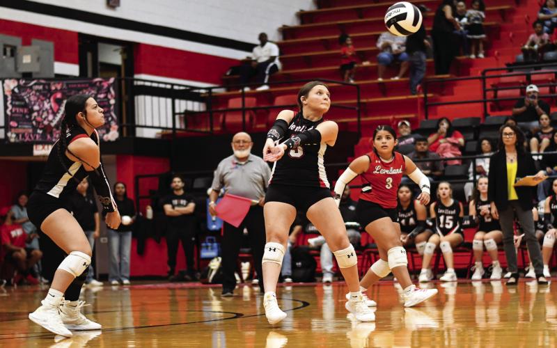 MAKE A PLAY - Senior defensive specialist Tiffany File twists to make a play on the volleyball as her teammates Yara Carillos and Karsyn Gaona watch during Levelland’s volleyball match against Frenship Memorial this past Tuesday night at Levelland High School. File would record six service points and an ace in the Loboettes 3-0 loss to Memorial. (Staff photo by Jentezen Smith)