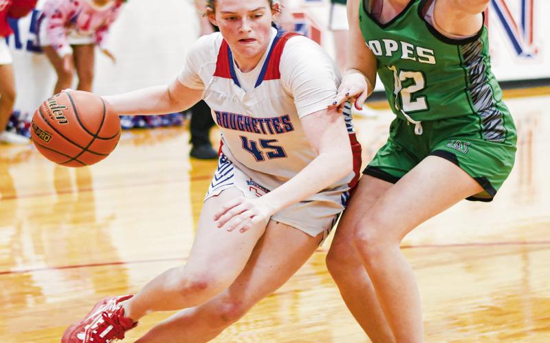 ROUGHETTE VERSUS LADY EAGLE - Sundown Roughette Kelbie Powell drives to the basket while Ropes Lady Eagle Annabelle Falls plays defense on her during their district matchup this past Friday in Sundown. (Staff photo by Jentezen Smith)