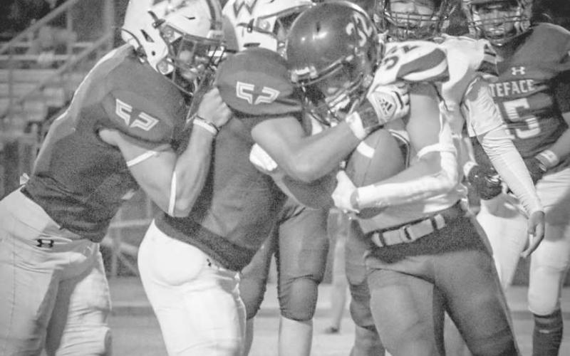 GROUPTACKLE - Whiteface Antelopes Damien Casteneda and Ethan Kauffman both made the tackle on the Elida ballcarrier this past Friday during the team’s homecoming game. (Staff photo by Aalijah Soliz)