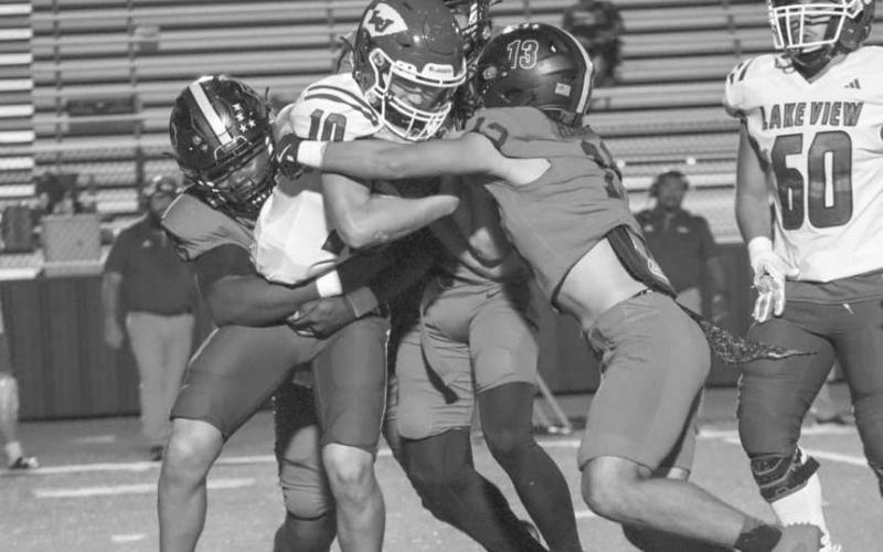 WRAPUP- Levelland Lobos Gabe Hernandez and Tanane Brackens wrapped up the Lake View ballcarrier this past Friday at home in the team’s win. (Staff photo by Aalijah Soliz)