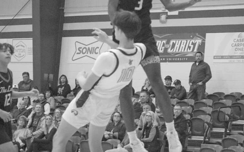 NOT TODAY - Levelland Lobo Eryk Jones avoided contact to draw the blocking foul while making the layup during the team’s game against Lubbock Christian. (Staff photo by Aalijah Soliz)