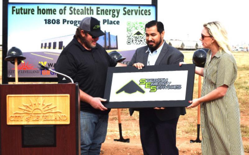 Stealth Energy co-owner, president and CEO Jeramiah Maynard was presented with a special plaque by assistant city manager Justin Balderas and Mayor Breann Buxkemper at the company’s groundbreaking ceremonies on Friday. (staff photo)