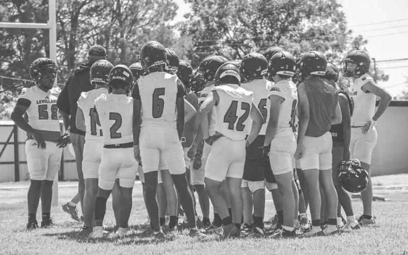 HUDDLE UP - The Levelland Lobos Varsity Squad huddled up around the coaches this past Monday at the Levelland High School for the first day of two-a-days. (Staff photo by Aalijah Soliz)