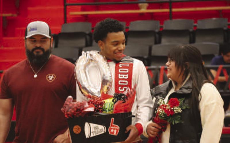SENIOR - Levelland Lobo Jayden Castillo was walked out by his parents Maria Castillo and Rito Morales this past Tuesday during the teams Senior Night. Jayden’s future plans include playing basketball at the next level in college. Castillo’s favorite quote is “The moment you give up is the moment you let someone else win.” (Staff photo by Aalijah Soliz)