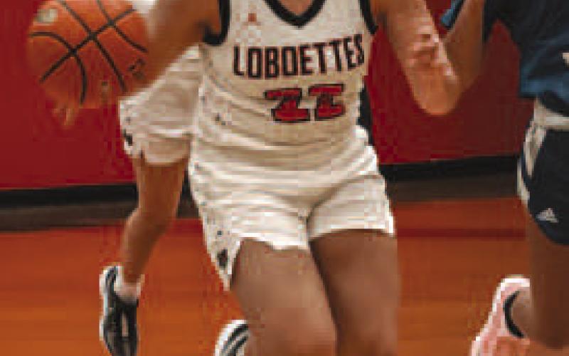 DOWNHILL - Loboette Olivia Velardez grabbed the rebound during the teams game to get down the court to get the team rolling on the offensive side of the ball. (Staff photo by Aalijah Soliz)