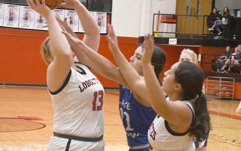 OFFENSIVE BOARD- Laci White had eight points in a 72-18 Levelland girls’ high school basketball home win over the Lake View Maidens last Friday. The Loboettes travel to Snyder Friday for a 6:15 p.m. game. Also pictured if Olivia Velardez. (Photo Courtesy of Jay Kelley)