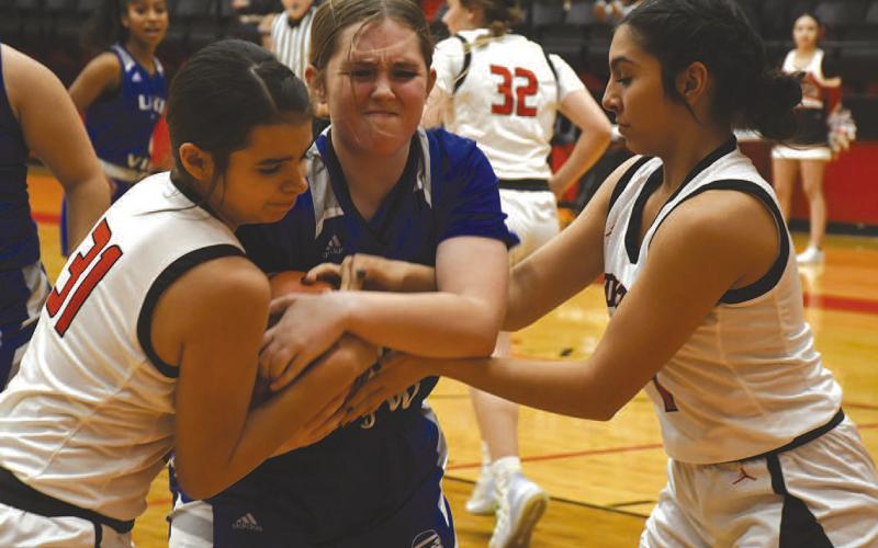 BATTLING- Leilani Sanchez and Mia Morin battled for the ball with a Lake View Maiden in a 72-18 Levelland Loboette girls’ high school basketball home win last Friday. The Loboettes travel to Snyder on Friday for a 6:15 p.m. game. (Photo Courtesy of Jay Kelley)