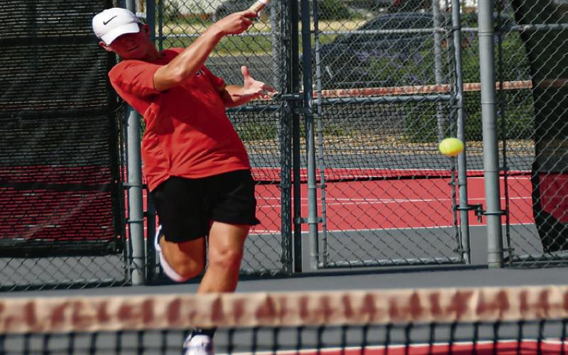POWER SWING – Reese Payton puts extra power into his swing to send it back to his opponents during Levelland’s match at home against Greenwood on August 19. (Staff photo by Jentezen Smith)