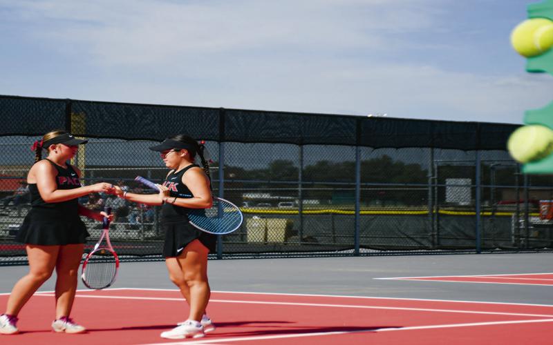 DAP IT UP – Levelland tennis teammates Teagan Brothers and Madison Almager dap it up after scoring a point in their double’s matchup against Big Spring at the Levelland Tennis Courts on August 2. (Staff photo by Jentezen Smith)