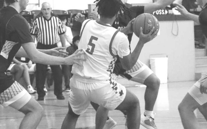 UNDER PRESSURE - Levelland Lobo Sean Landrum broke the full press on the Hale Center defense during the teams contest in the Littlefield Tournament last week. (Staff photo by Aalijah Soliz)