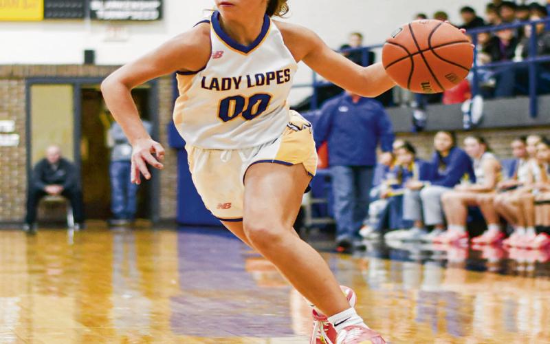 SANDERS ON THE DRIVE - Whiteface junior point guard Lainey Sanders drives the basketball during a game in the Way Out West Tournament last weekend. Sanders had eight points against West Texas. (Staff photo by Jentezen Smith)