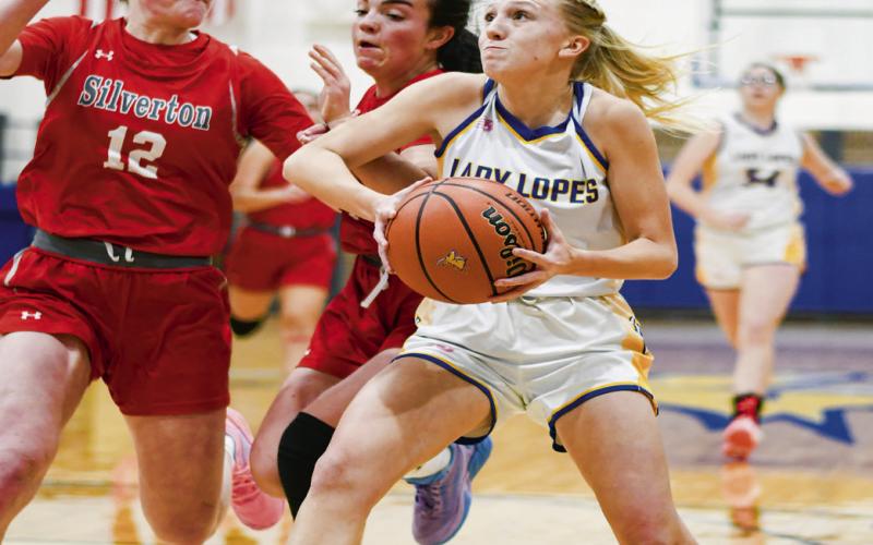 BLANKENSHIPATTACKS THE PAINT - Whiteface senior guard Emily Blankenship attacks the paint during their game against Silverton last weekend. Blankenship had 14 points against West Texas. (Staff photo by Jentezen Smith)