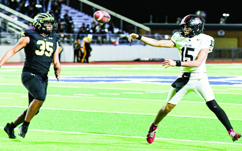 SCRAMBLE DRILL - Levelland quarterback Ethan Salazar scrambles to find an open receiver and makes a throw dur ing their playoff football game against Seminole in November at Frenship High School. (Staff photo by Jentezen Smith)