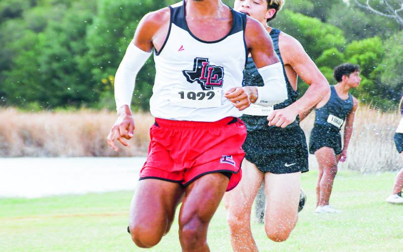 MID-RACE COOL-OFF - Levelland’s Saul Hernandez gets hit with water to cool off in the middle of his cross country race at Mae Simmons Park in October. (Staff photo by Jentezen Smith)