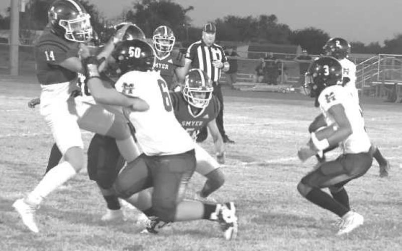 FOLLOW THE BLOCKS - Morton’s A.J. Mendoza got some good blocks from teammates as the Indians downed the Smyer Bobcats 296 in Smyer last Friday. Morton will be in New Home, while Smyer travels to Seagraves next Friday. Both games start at 7 p.m. (Photo by Jay Kelley)