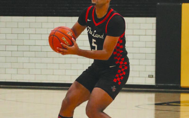 PASS FIRST - Levelland Lobo Sean Landrum looked for a teammate to pass the ball to during the team’s game against the Snyder Tigers on the road. (Staff photo by Aalijah Soliz)
