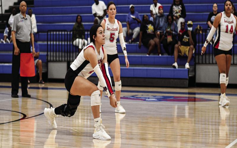 MAKE THE DIG - Senior Yara Carillos lunges to make the dig as her senior teammates Tiffany File and Trinity Wafer watch during Levelland’s volleyball match against Lubbock Estacado this past Tuesday at Estacado High School. The Loboettes would end up sweeping the Matadors. (Staff Photo by Jentezen Smith)