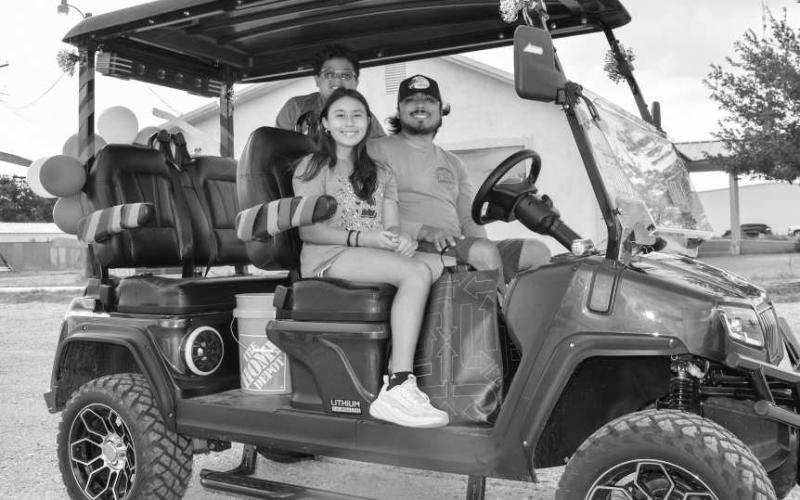 PARADE READY – Pictured are Emilio and Alexandria Lopez along with Mayson Escamilla who were ready to go in a decked-out golf cart before the Oil Patch Days Parade last Saturday. (Staff photo by Ada Niederhauser)
