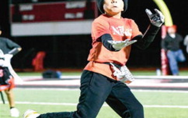 REEL IT IN - Kai Penner focuses to reel in a pass during the 8u Levelland Lobos football practice at Lobo Stadium this past Monday. They’ll be playing at the Star in Frisco for an NFL Regional Flag Football tournament over the weekend. (Staff photo by Jentezen Smith)