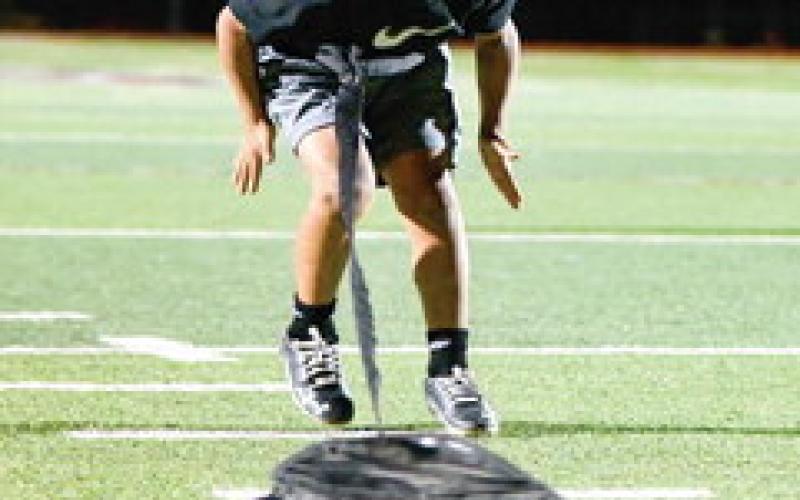 WEIGHTED BACKPEDAL - Ryland Golightly practices his backpedal while pulling a weight during the 8u Levelland Lobos football practice at Lobo Stadium this past Monday. They’ll be playing at the Star in Frisco for an NFL Regional Flag Football tournament over the weekend. (Staff photo by Jentezen Smith)