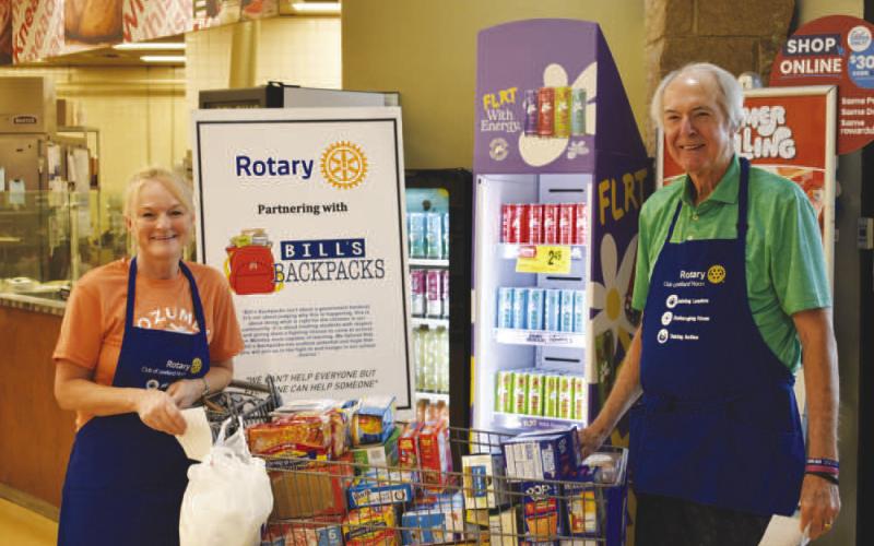 FOOD COLLECTION – Pictured is Phelps Blume and Amber Hinson of the Noon Rotary Club collecting donations for Bill’s Backpacks on Saturday. The club welcomes volunteers who help collect donations on the second Saturday of every month. The club collected $1,322.97 worth of items this past Saturday.They thank eveyone that donated (Staff photo)