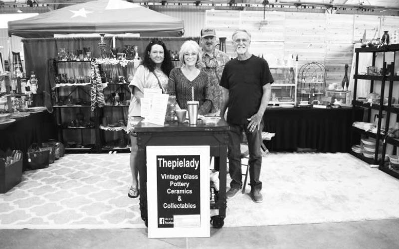 SHOPPINGAND SOCIALIZING - Pictured are Michelle Wischkaemper, Gail Kennedy, Hockley County Sheriff Chris Wischkaemper and BJ Kennedy who were found conversing at a booth on Saturday at the Yucca Blossom Trade Day event at the Mallet Event Center. (Staff Photo by Ada Niederhauser)