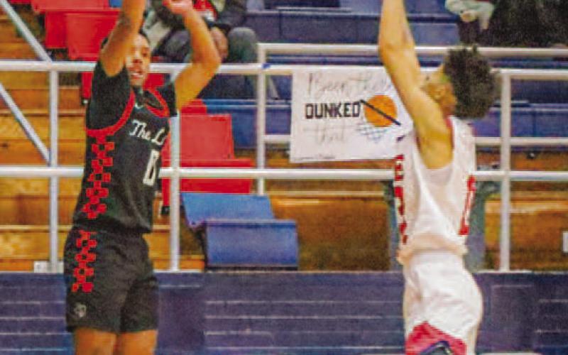 SPLASH - Levelland athlete Jayden Castillo shot the ball for a Lobo three-pointer during the teams season opener last Friday in Plainview. (Staff photo by Aalijah Soliz)