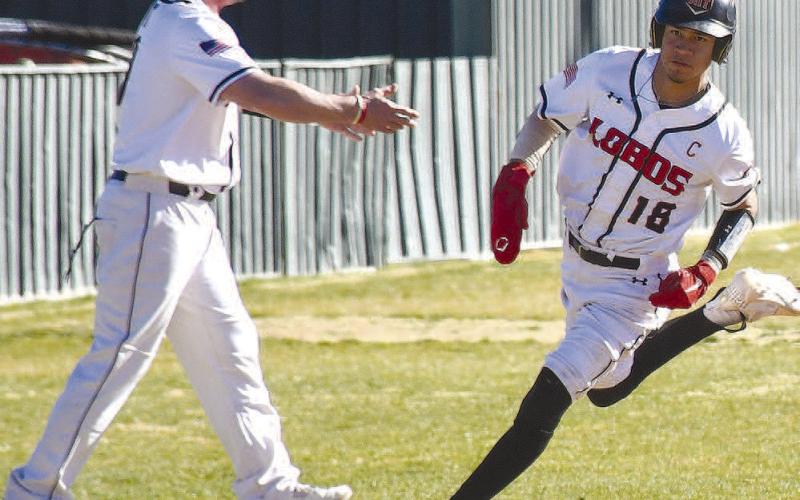 HEADED HOME- Lobo Joel Pena rounded third base on his way to scoring a run during the Levelland Line Drive Classic last weekend. Also pictured is Levelland Head Coach Chris Portwood. The Lobos had Tuesday off but will be back on the field Thurdsay for the Greenwood Tournament. (Staff Photo by Dom Puente)