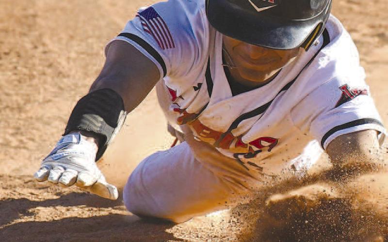 BACK TO FIRST- Lobo Noah Tienda slid back into first just beating the tag during the Levelland Line Drive Classic last weekend. (Staff Photo by Dom Puente)