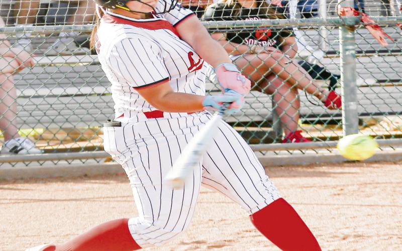 TEE OFF ON IT - Levelland Loboette Madi Seat tees off on a pitch during their district softball game against Liberty this past Tuesday at Levelland High School. (Staff photo by Jentezen Smith)