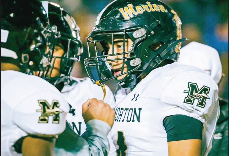 LISTEN TO COACH - Morton junior running back and linebacker Luis Aguirre listens intently to one of his coaches during a timeout in their football game against Hale Center this past Friday. Aguirre would finish the game with 28 rushing yards and two tackles. (Photo provided by Gillian Ruiz)