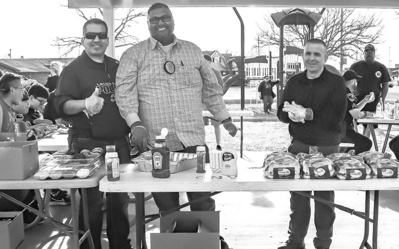 SERVICE WITH A SMILE- The Levelland Police Department hosted their first “Cops and Communities” Thursday at the Kauffman Park. Pictured from right to left are: Detectives Lopez, Ramirez and Whooten preparing food for community members and first responders attending the event. (Staff photo by Essence Childers)