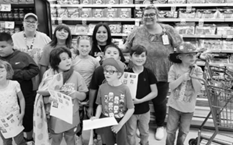 SHOP TIL YOU DROP - Mrs. Bednarz's from South Elementary made a trip to United to purchase items to make trail mix. Students learned where to find items in the store and how to shop on a budget. Pictured from left to right, front row: Bristol McQueen, Liliana Ryan Garza, Cooper Powers. Middle row: Austyn Ruiz, Arianna Young, Peyton Eakin, Jaxson Estrada, Jebediah Castaneda, Dylan Oliver Back row (teachers): Christina Washington, Cynthia Victorino, Megan Bednarz. (sumbitted photo by Cristal Isaacks)
