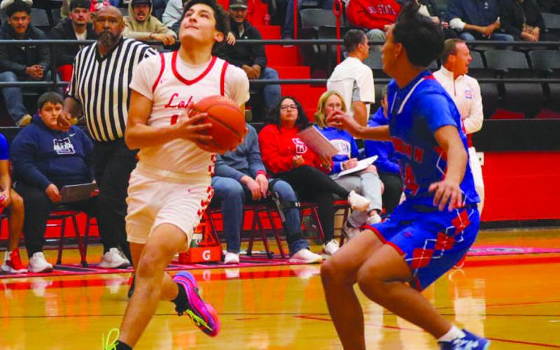 DRIVING IN - Levelland Lobo Ethan Salazar drove into the paint during the team’s game against Sundown before their district opener on the road. (Staff photo by Aalijah Soliz)