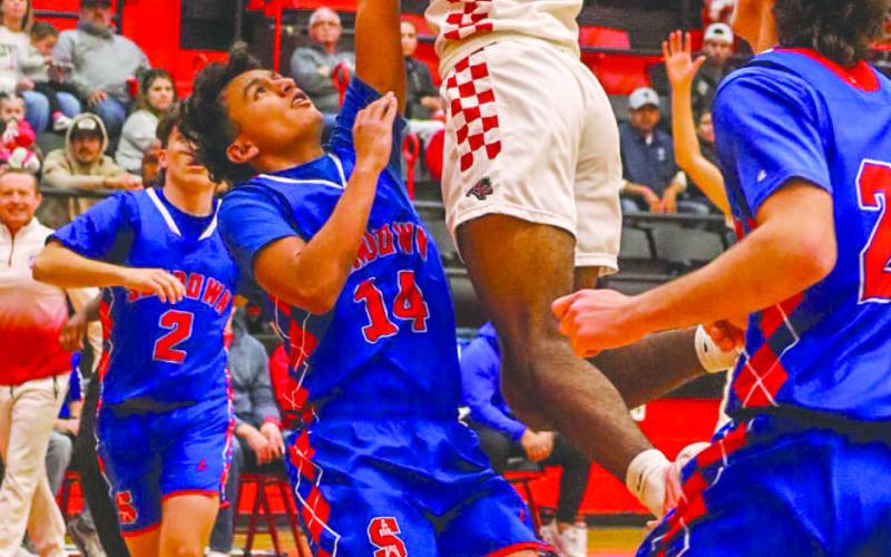 CAN’T STOP ME - Levelland Lobo Eryk Jones went vertical over the Sundown defender during the team’s game at home before the start of district play. (Staff photo by Aalijah Soliz)