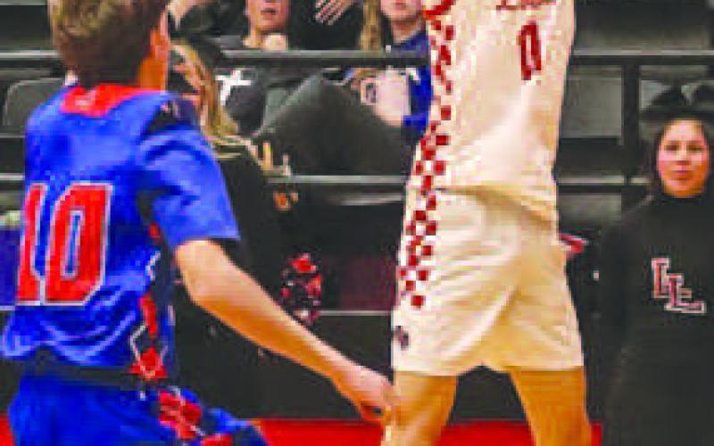 THREEFROMDEEP- Levelland Lobo Anthony Gonzalez shot the ball over the Sundown defender closing out on him during the team’s game at home before the start of district play. The Lobos played against the Big Spring Steers this Tuesday at home for district play after their tough opener against Lubbock Cooper Liberty.(Staff photo by Aalijah Soliz)
