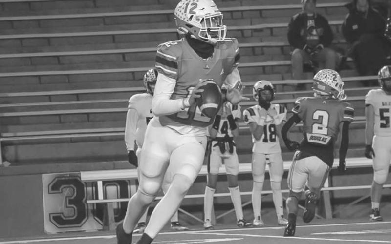 THROW ON THE RUN - Ropes Eagle Kade Franklin rolled out of the pocket during the team’s last game against Gruver in Canyon. (Staff photo by Aalijah Soliz)