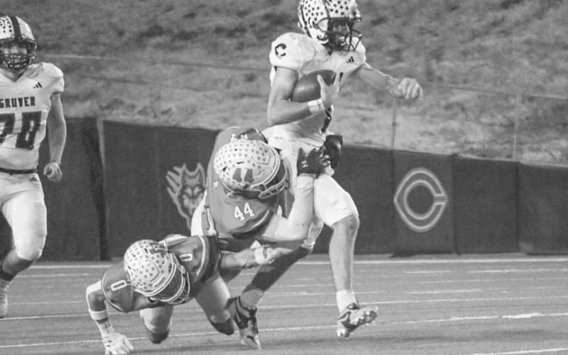 DRAGGED DOWN - Ropes Eagles Branson Simental and Victor Saenz dragged down the Gruver ballcarrier during their last game of the season in Canyon. (Staff photo by Aalijah Soliz)